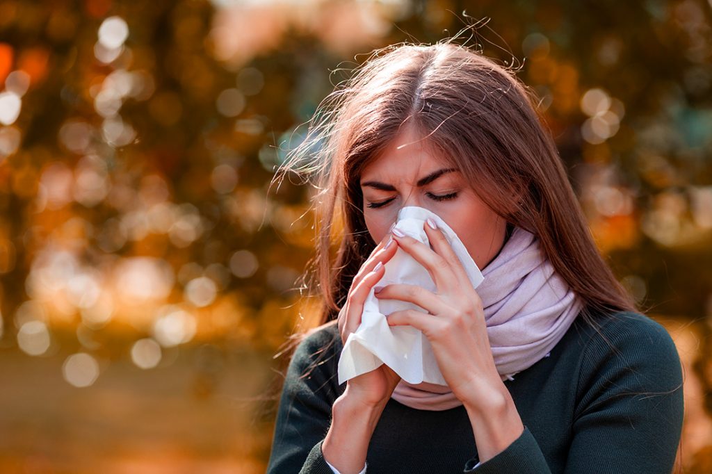 Young woman dealing with fall allergies