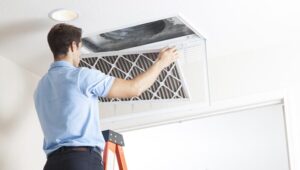 Technician performing air duct cleaning service in a residential home in Aliquippa, PA.